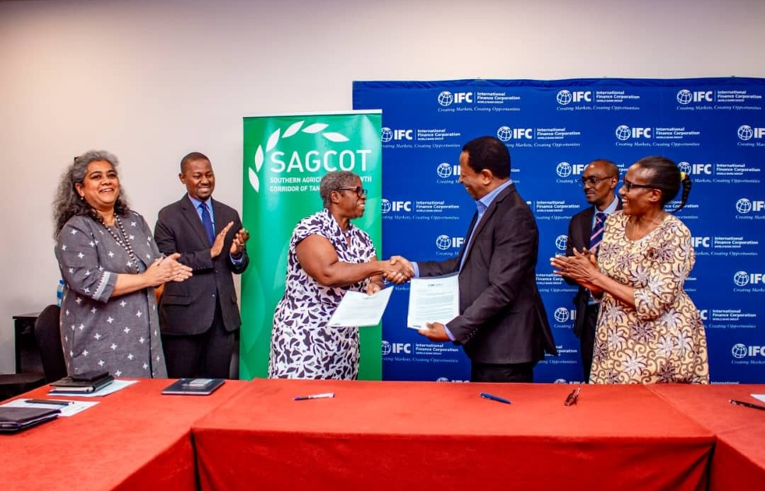 Geoffrey Kirenga, CEO of SAGCOT Centre Ltd. (right), and Ms Martin Valcin, IFC Country Manager for Rwanda, Tanzania, and Uganda (left), shake hands and exchange Letters of Engagement on October 7, 2024, shortly after signing. Applauding the moment is Ms Paramita Dasgupta, Manager for Country Advisory and Economics, Eastern and Southern Africa, IFC (far left), and Mr  Gilead J. Teri, Executive Director of TIC (second from left). On the right side, Mr. Leopold Shayo, Director of Research and Information Systems at TIC (second from right), and Ms. Maria Ijumba, Head of Cluster and Partnership Development at SAGCOT (far right), also join in celebrating the partnership. The partnership aims to strengthen agricultural transformation in Tanzania by improving access to finance for Tanzanian agribusinesses aligning with the country’s national agricultural goals.